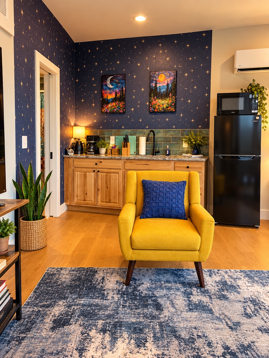 Gold armchair in front of the star-patterned kitchenette wall