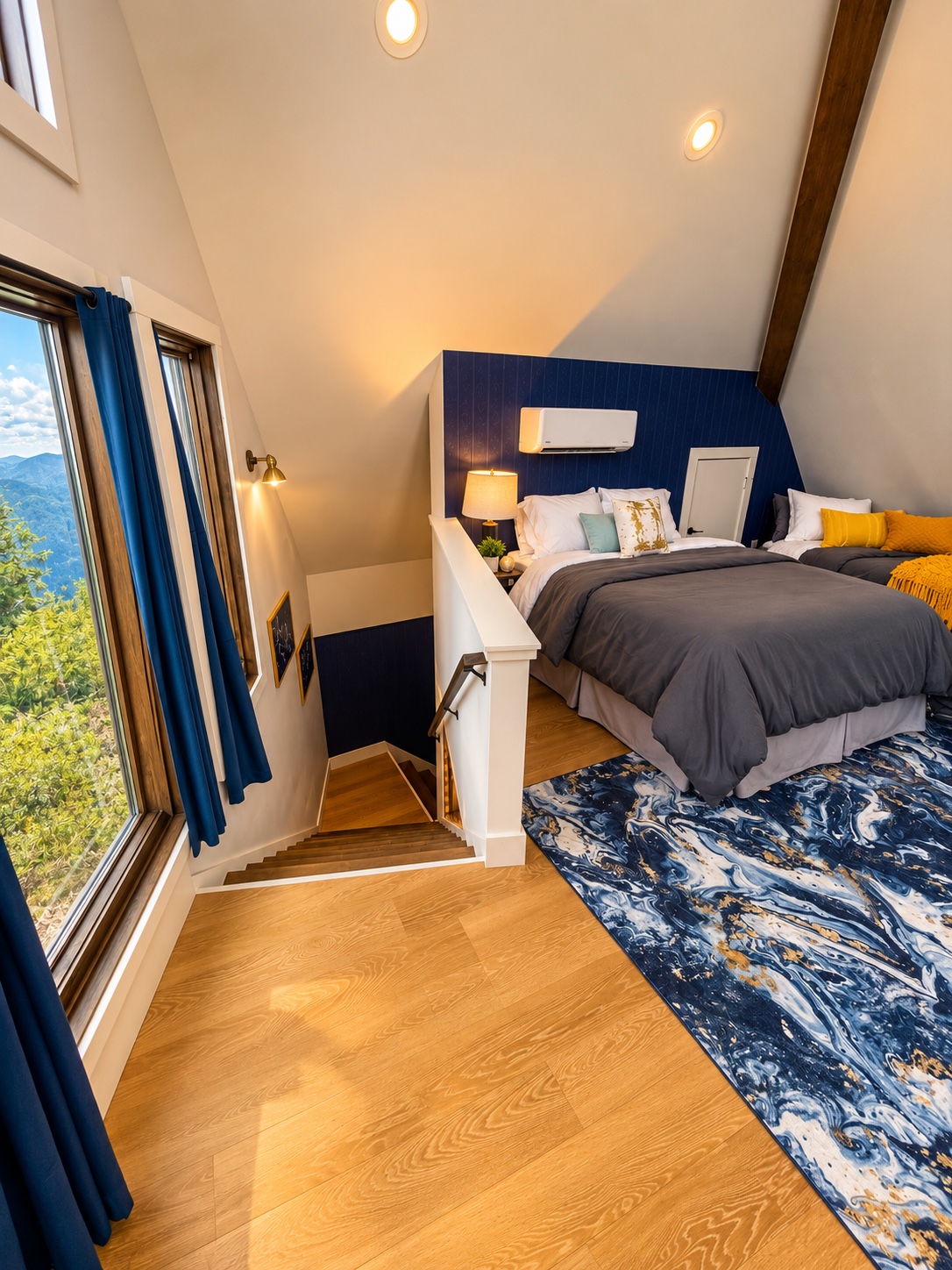 Loft sleeping area beside the staircase and mountain-view windows
