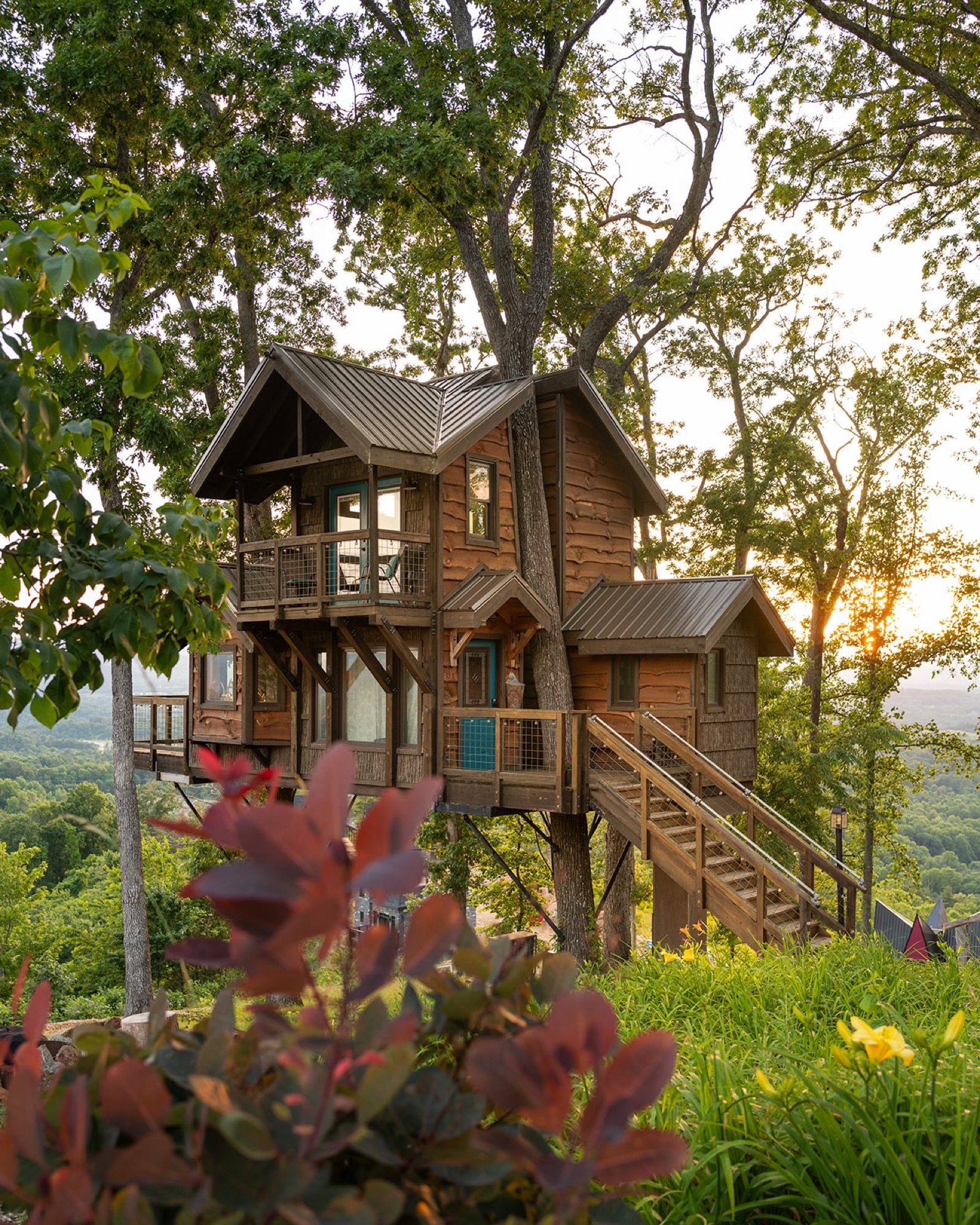 Sanctuary — full treehouse on stilts at golden hour